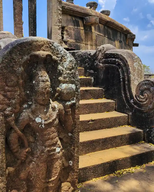 A carved guard stone beside ancient temple steps